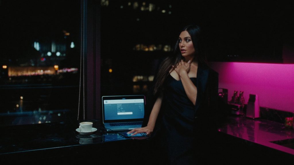 A model at a kitchen counter at night with a banking app open
